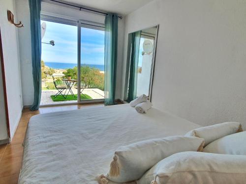 a bedroom with a large bed with a large window at Vistas al Mar y la Piscina en Calarreona - by Aloha Palma in Águilas