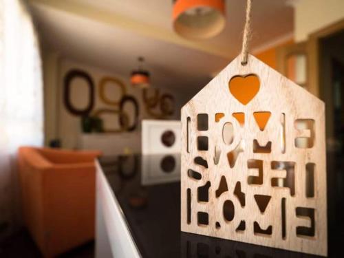 a wooden tag with a heart on it hanging in a room at Reade homes in Luton