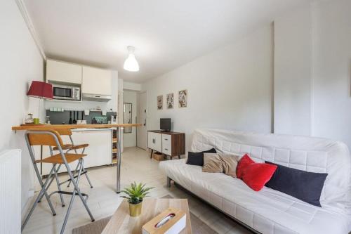 salon z białą kanapą i kuchnią w obiekcie Studio Plages Vélodrome by Villa Reiala w Marsylii