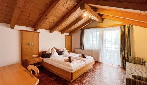 a bedroom with a large bed and a large window at Hallerhaus in Altenmarkt im Pongau
