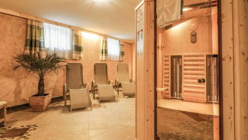 a waiting room with chairs and a potted plant at Hallerhaus in Altenmarkt im Pongau