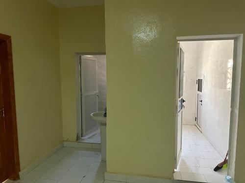 an empty bathroom with a sink and a toilet at Darius Adefon in Nouakchott