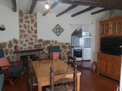 a living room with a table and a tv at EL CASTELLET in Traiguera