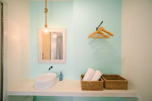 a bathroom with a sink and a mirror at BIG WAVES BOUTIQUE HOTEL SIARGAO in General Luna