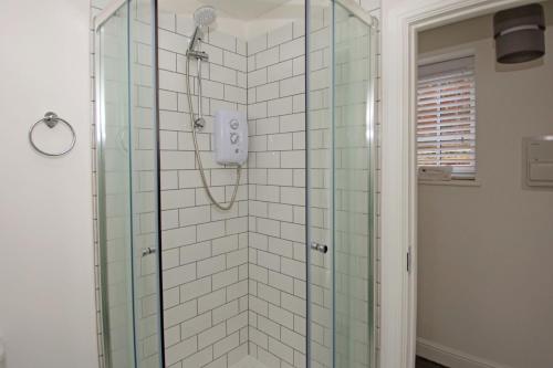 a bathroom with a shower with a glass shower at Hartshorne House in Telford