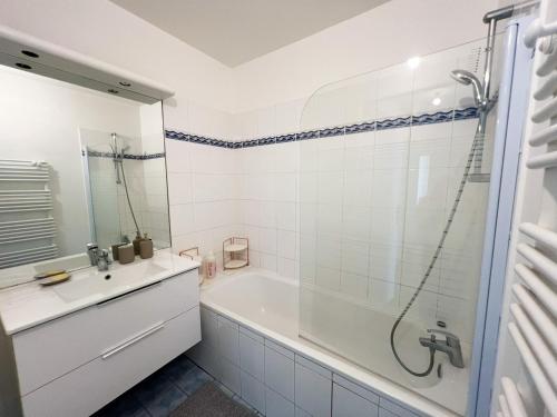 La salle de bains est pourvue d'une douche, d'une baignoire et d'un lavabo. dans l'établissement EXIGEHOME - Grand T4 en centre ville à 10 min du RER A, à Maisons-Laffitte