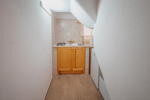 a small kitchen with a sink and a counter at Uno Scorcio sulla Rocca by Wonderful Italy in Cefalù