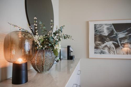a vase with flowers on a table in a room at Clarion Hotel Arlanda Airport Terminal in Arlanda