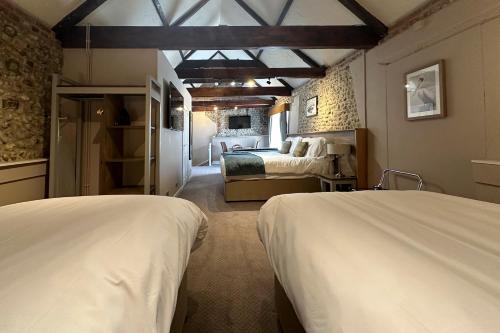 a bedroom with two beds and a room with a bed sqor at The Lobster in Sheringham