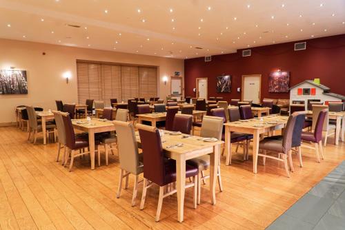 a dining room with tables and chairs at Caladh Inn in Stornoway