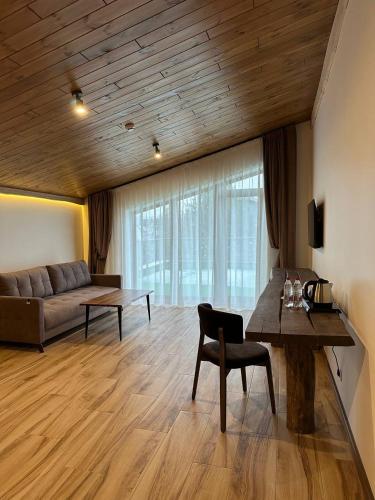 a living room with a couch and a table at Фільварок Кмитів in Kosharishche