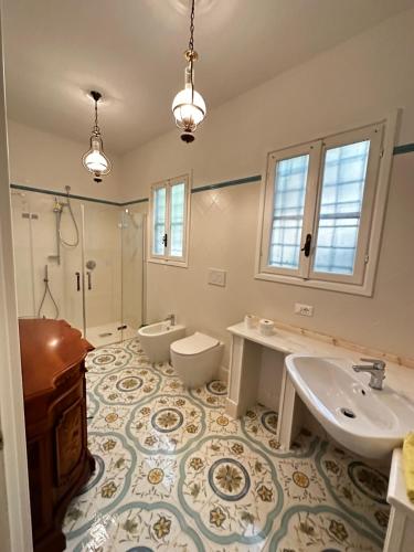a bathroom with two sinks and a shower at Villa San Giorgio vista mare Alassio in Alassio