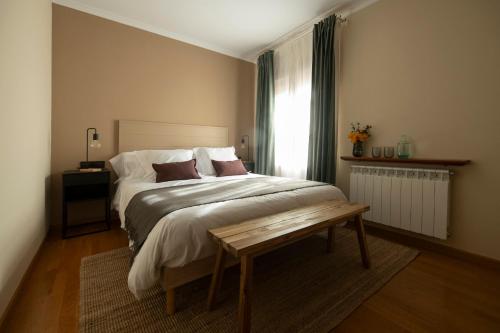 a bedroom with a large bed and a table at Hotel Siuranella in Siurana