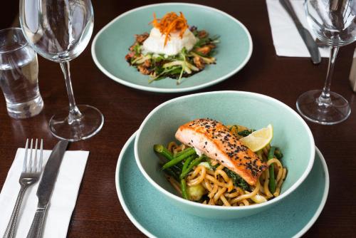 a table with two plates of food and a bowl of pasta at Hotel Ceann Sibeal in Dingle