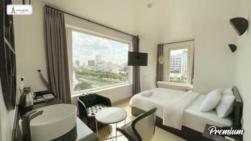 a hotel room with a bed and a large window at A In Hotel Riverside in Ho Chi Minh City