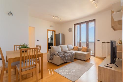 a living room with a couch and a table at Wanderlust Experience Portsea Apartment in Giovinazzo