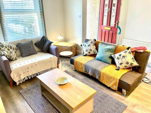 a living room with a couch and a coffee table at Modernised cottage Sleeps Six in Ore