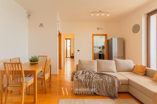 a living room with a couch and a table at Wanderlust Experience Portsea Apartment in Giovinazzo