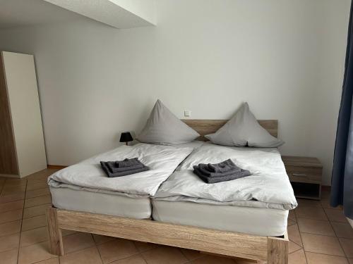 a bedroom with a bed with two pillows on it at Eifel Ferienwohnung Thiel in Oberstadtfeld