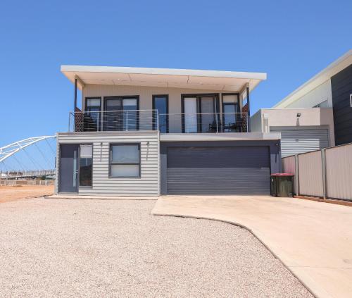 a large house with a garage in a driveway at Exmouth Marina Escape in Exmouth