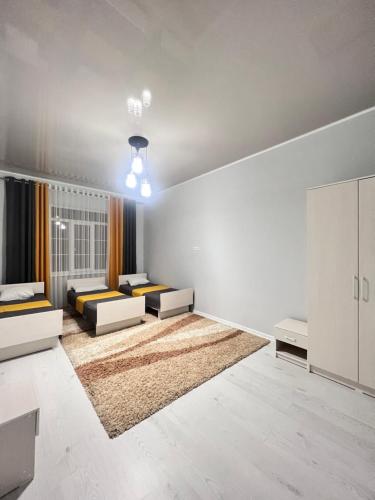 Ένα ή περισσότερα κρεβάτια σε δωμάτιο στο Гостевой дом Дастан, Guest House Dastan