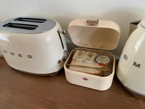 two toasters sitting next to each other on a table at BeachBoys - Retro Caravan AirStream in Jeju