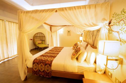a bedroom with a large bed with a canopy at ONENESS Rishikesh by Ganga Kinare - A Luxury Wilderness Resort in Rishīkesh