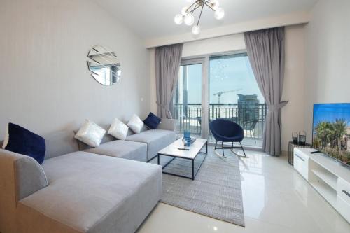a living room with a couch and a table at Elegant Waterfront 1BHK in Dubai Creek Harbour in Dubai