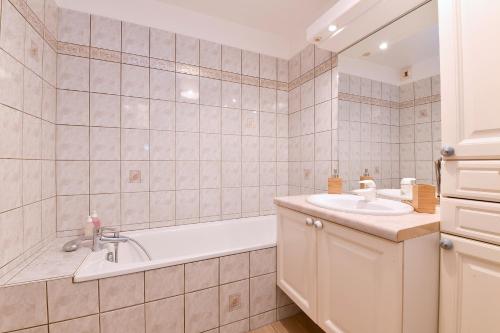 a bathroom with a tub and a sink at Appartement The Fairytale in Colmar