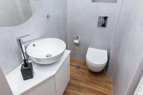a white bathroom with a sink and a toilet at Kallithea Modern Living with Designer Touch in Athens