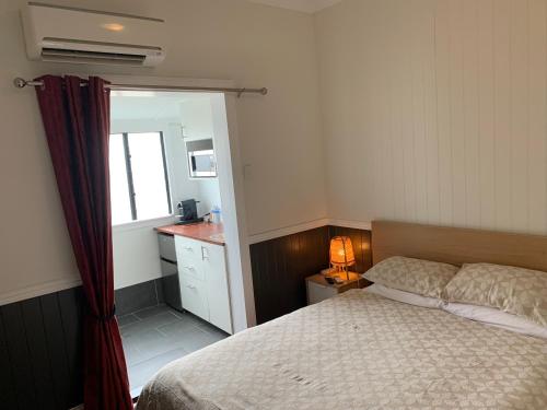 a bedroom with a bed and a sink and a mirror at West End Studio 2 in Brisbane