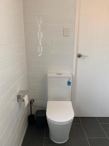 a bathroom with a white toilet in a stall at West End Studio 2 in Brisbane