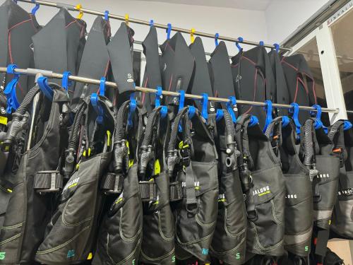 a bunch of umbrellas are lined up on a rack at MC Bunaken Stay Diving Trip's in Bunaken