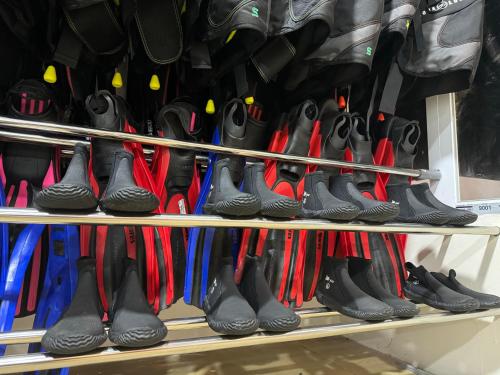 a row of shoes on a shelf in a store at MC Bunaken Stay Diving Trip's in Bunaken