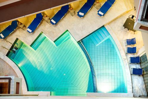 an overhead view of a building with blue chairs at Elina Hotel Apartments in Rethymno