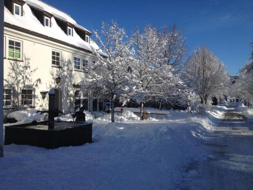 a building with snow covered trees in front of it at Die Remise - Schmidsfelden 12 - 88299 Leutkirch im Allgäu in Leutkirch im Allgäu