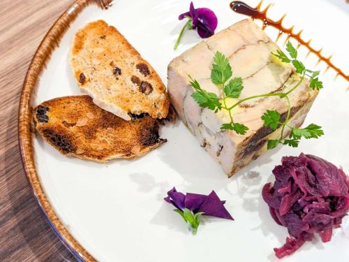 a plate of food with meat and bread and purple flowers at Novotel Paris Centre Tour Eiffel in Paris