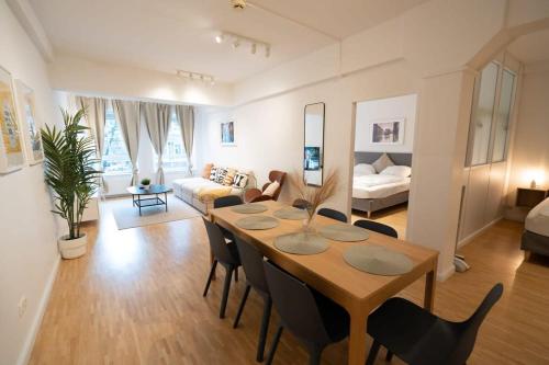 a dining room and living room with a table and chairs at Hamburg City Center Apartment in Hamburg
