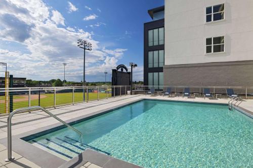 a swimming pool in front of a building at Hyatt Place Greensboro Downtown in Greensboro