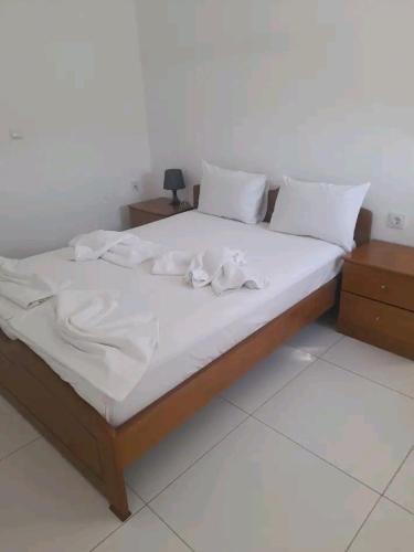 a bed with white sheets and pillows on it at Elvi Apartment 4 in Rakhónion