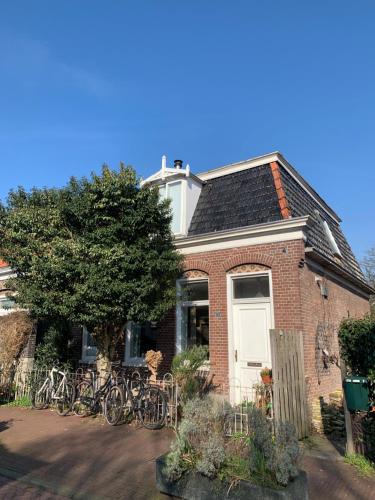 a brick house with bikes parked in front of it at Your own floor in authentic picturesque dikehouse - dijkhuis181 in Amsterdam