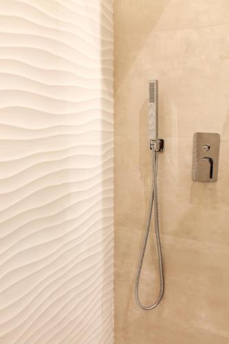 a shower with a shower head in a bathroom at La Casa Del Molo in Finale Ligure