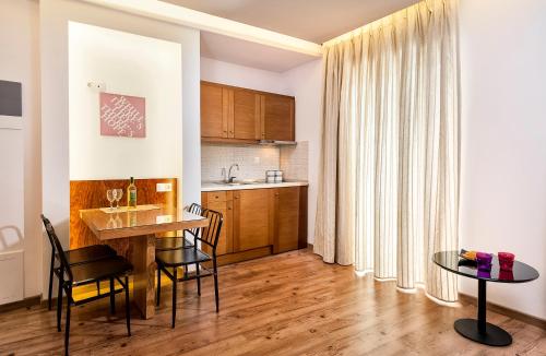 a kitchen and dining room with a table and chairs at Elina Hotel Apartments in Rethymno Town