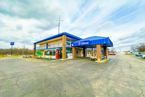 a gas station in a parking lot at Happy Stay Inn Madisonville I-69 By OYO in Madisonville