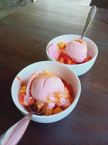 two bowls of food with ice cream on a table at Turtle Eco Beach in Matara