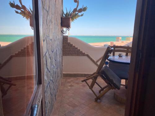 een balkon met een tafel en uitzicht op de oceaan bij Dar Rio Oro in Dakhla