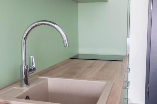 a kitchen with a sink and a counter at Apartamenty Wolności 6 self check-in 24h in Poznań