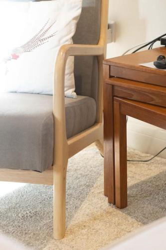a wooden chair next to a desk next to a bed at Secluded woodland annex between Mylor and Flushing in Falmouth