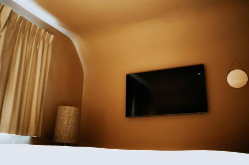 a flat screen tv on the wall of a bedroom at Casa Alta in Namur