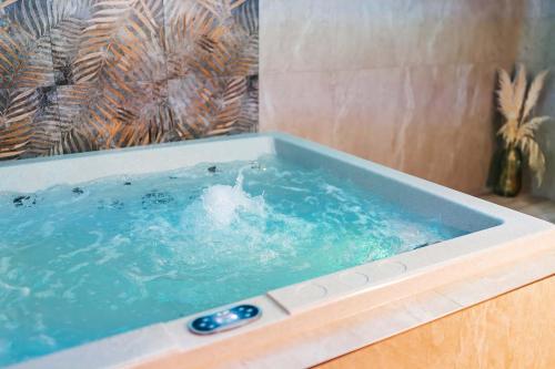 a bath tub with a thermometer in it at Apartmány Hájenka Oravice in Oravice